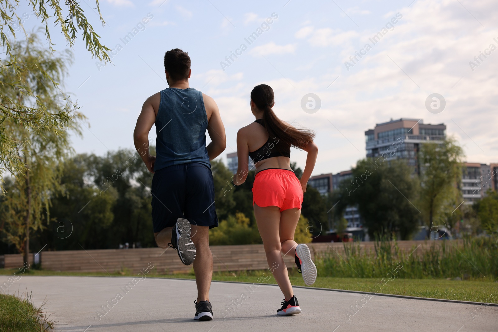 Photo of Healthy lifestyle. Couple running outdoors, low angle view