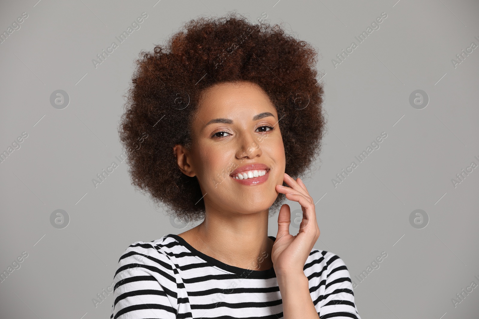 Photo of Portrait of beautiful young woman with glamorous makeup on grey background