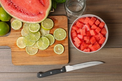 Fresh ingredients for making watermelon drink with lime on wooden table, above view