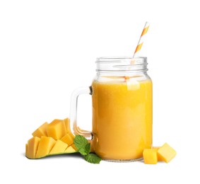 Photo of Mason jar of tasty mango smoothie and fresh fruit on white background
