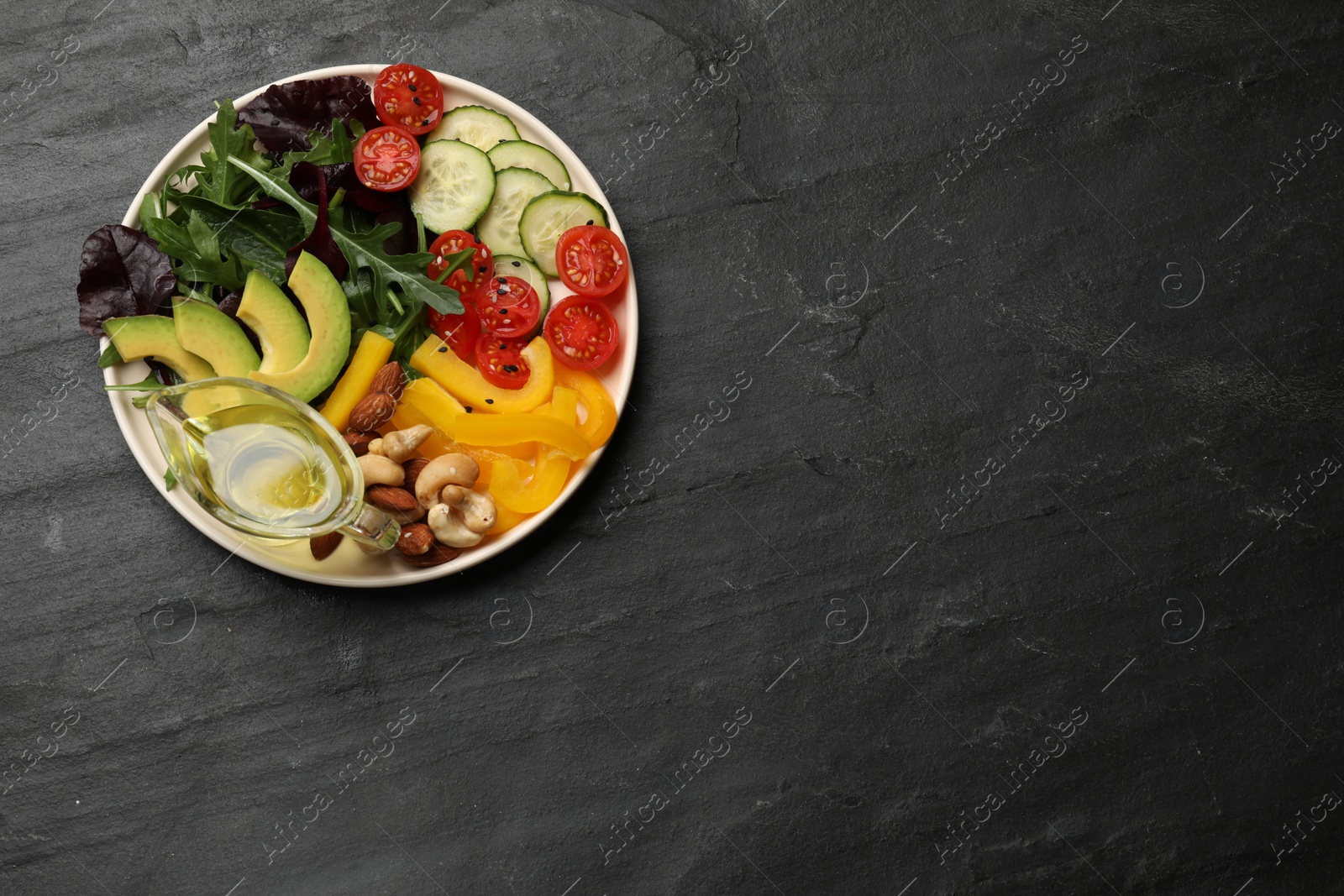 Photo of Balanced diet and vegetarian foods. Plate with different delicious products on black table, top view. Space for text