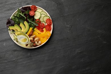 Photo of Balanced diet and vegetarian foods. Plate with different delicious products on black table, top view. Space for text