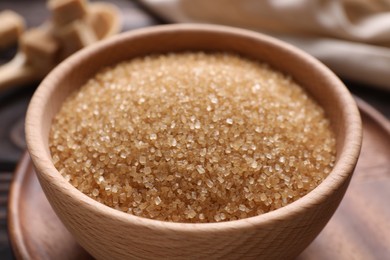 Photo of Brown sugar in bowl on table, closeup