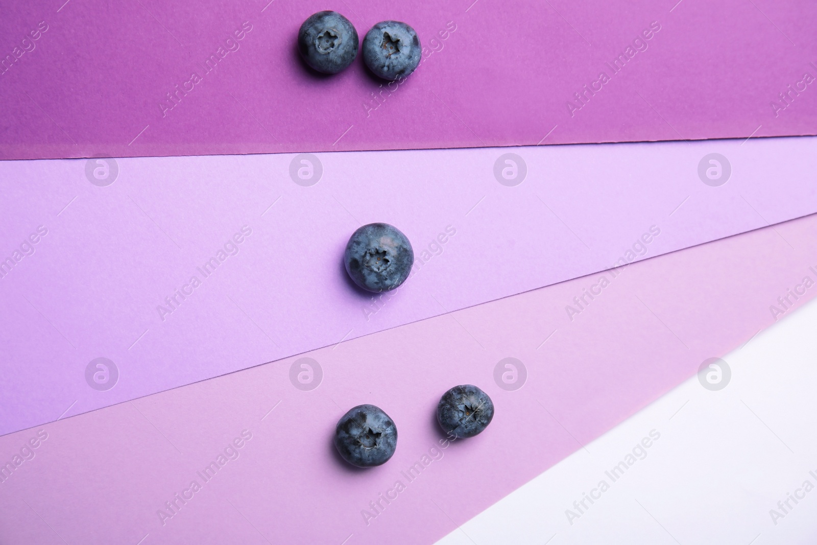 Photo of Flat lay composition with tasty blueberry on color background