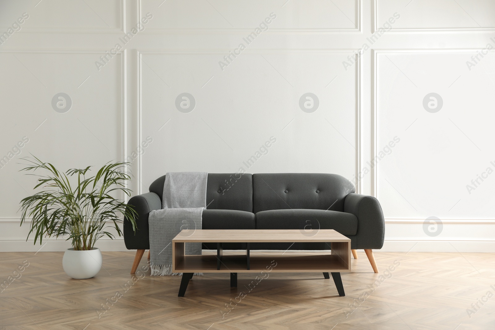 Photo of Stylish living room interior with comfortable grey sofa and wooden table