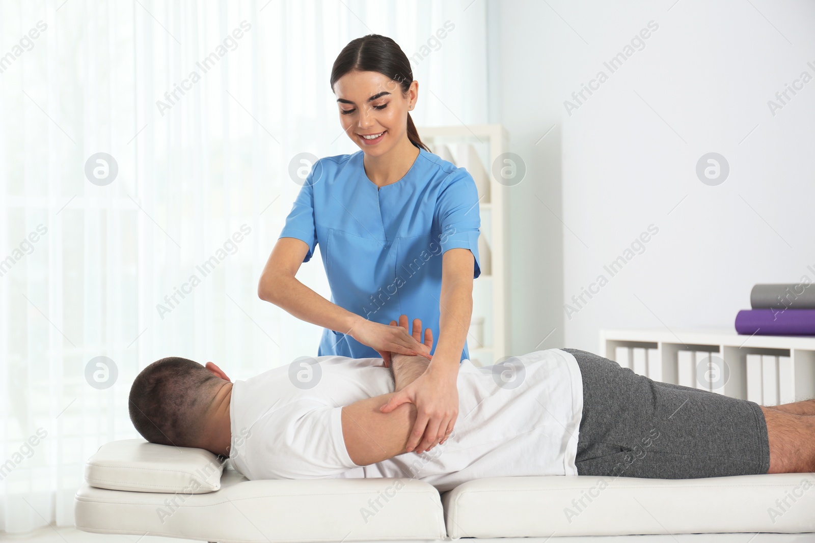 Photo of Doctor working with patient in hospital. Rehabilitation physiotherapy