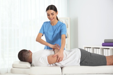 Photo of Doctor working with patient in hospital. Rehabilitation physiotherapy