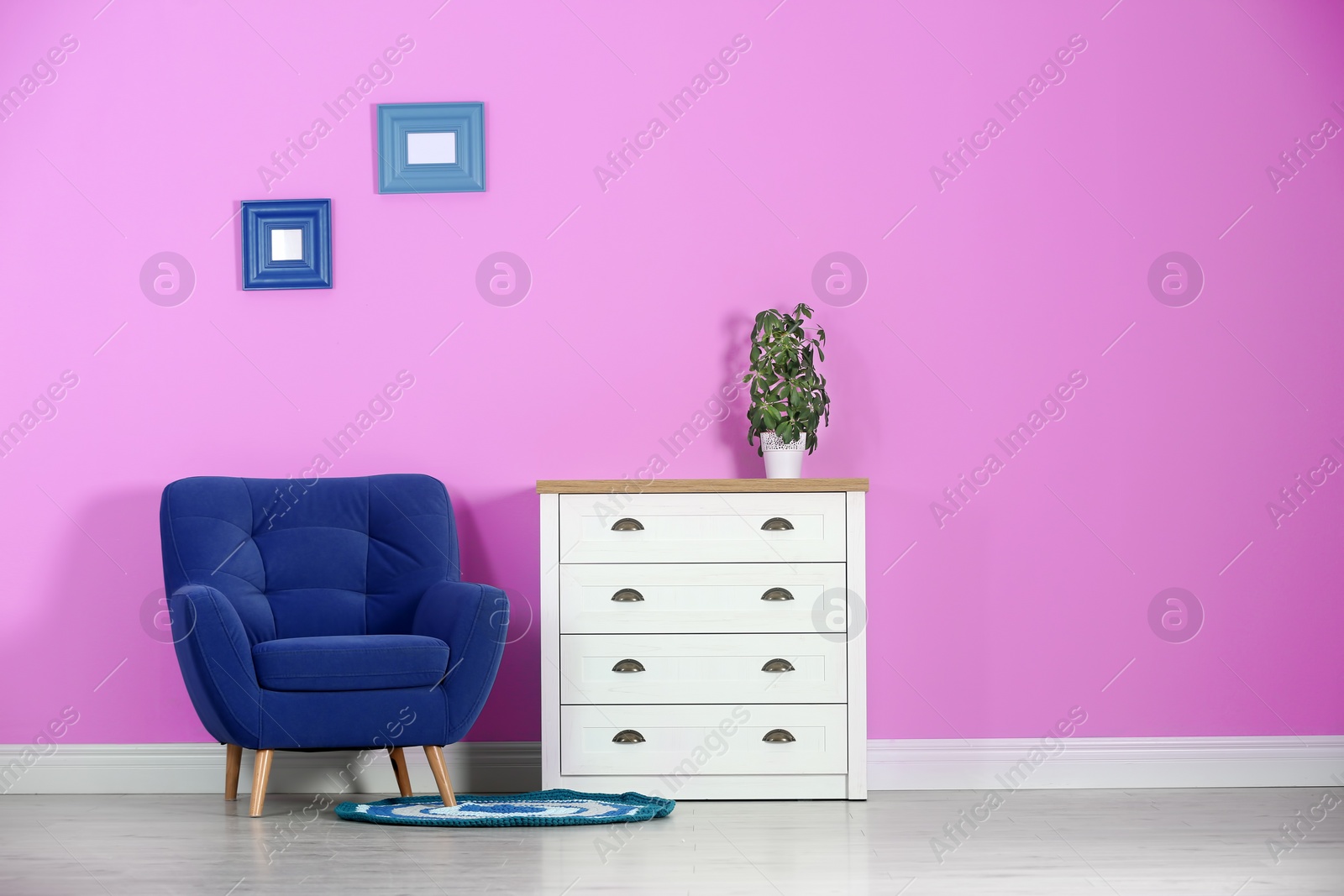 Photo of Stylish room interior with chest of drawers and space for text