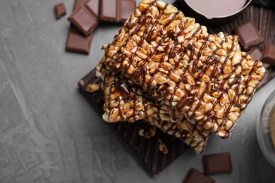 Delicious rice crispy treats on grey table, flat lay