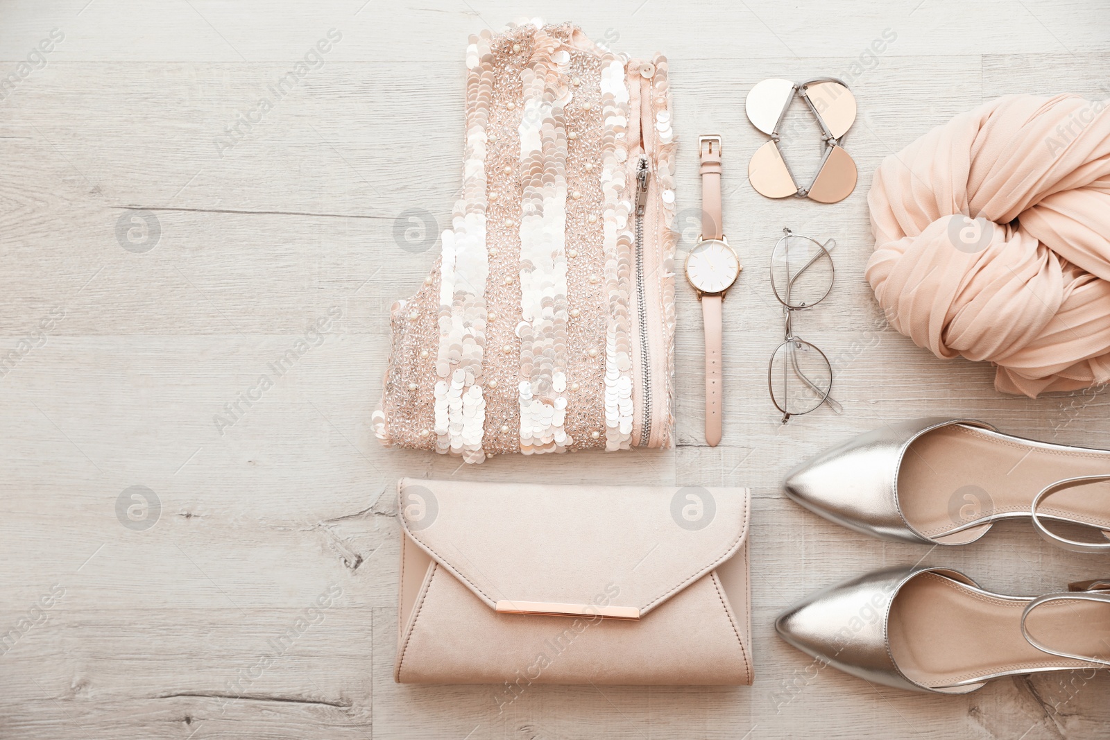 Photo of Flat lay composition with stylish female outfit and space for text on wooden background