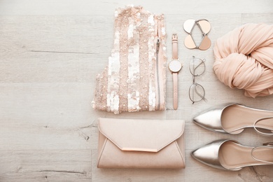 Flat lay composition with stylish female outfit and space for text on wooden background