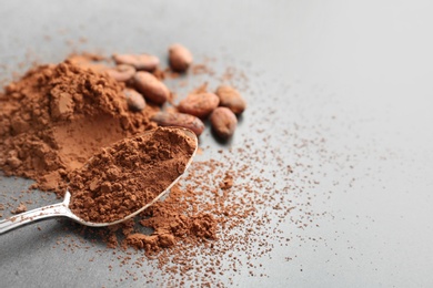 Photo of Composition with cocoa powder and beans on grey background