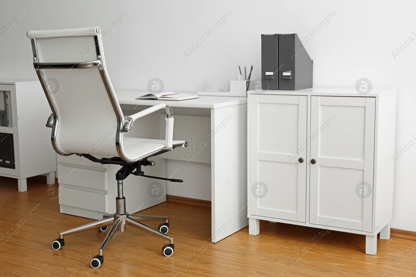 Photo of Stylish workplace interior with modern office chair and desk