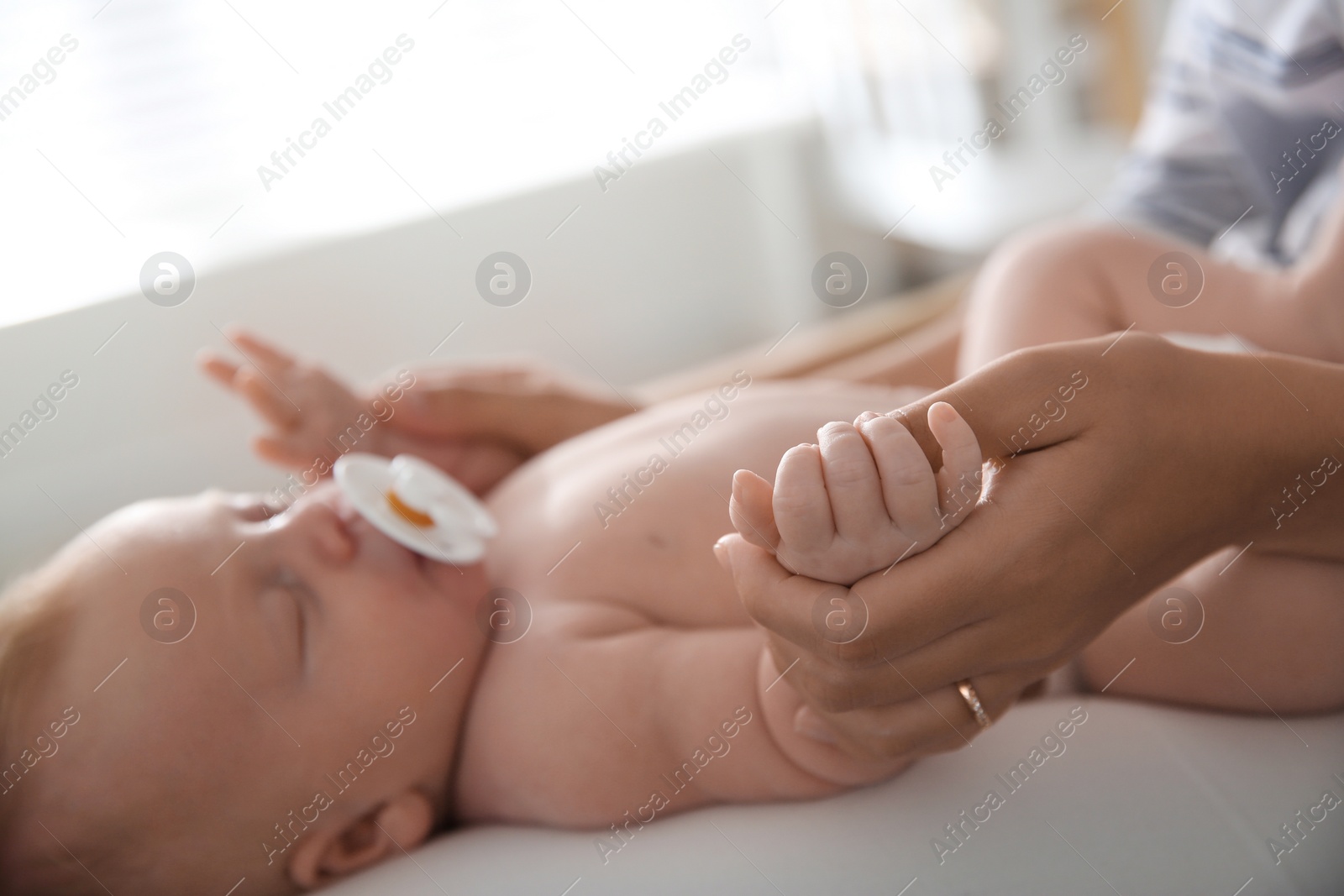 Photo of Mother with her newborn baby, closeup view