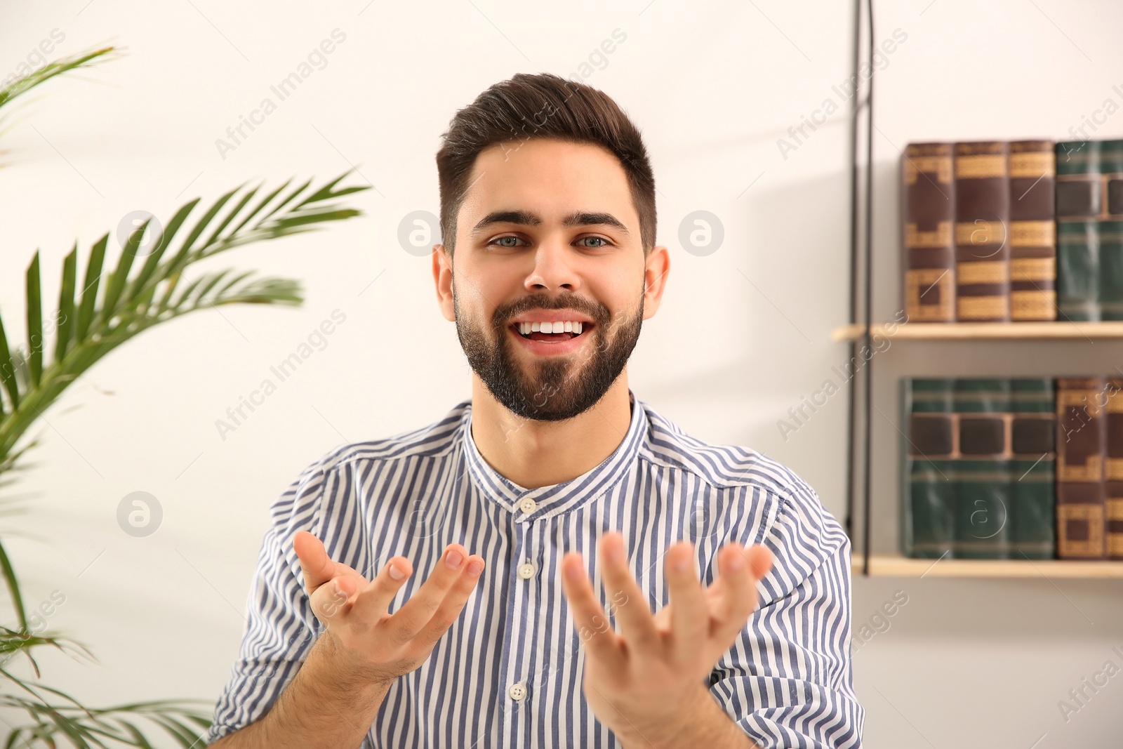 Photo of Young man using video chat at home, view from web camera