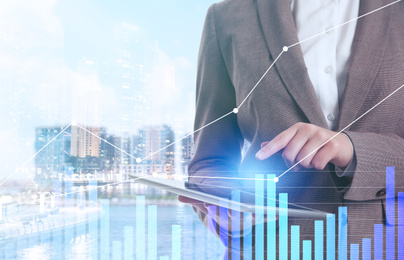Image of Double exposure of businesswoman with tablet and cityscape, closeup. Forex trading