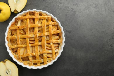 Tasty homemade quince pie and fresh fruits on grey table, flat lay. Space for text