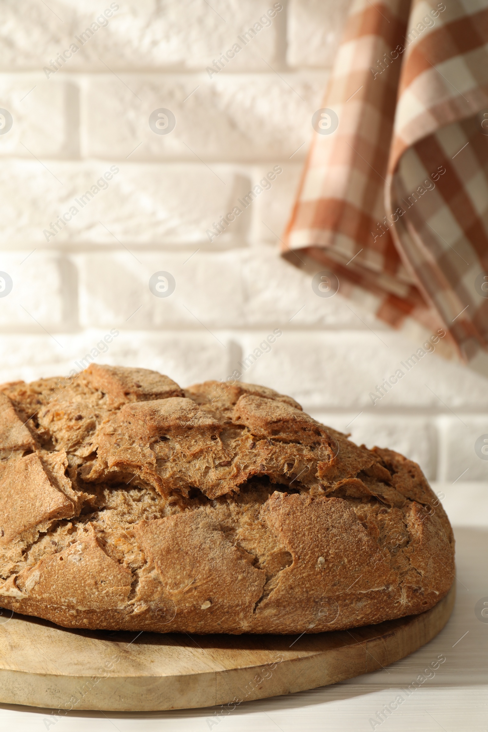 Photo of Freshly baked sourdough bread on white table