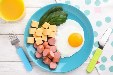 Photo of Flat lay composition with egg and cheese on white wooden table. Breakfast for kids