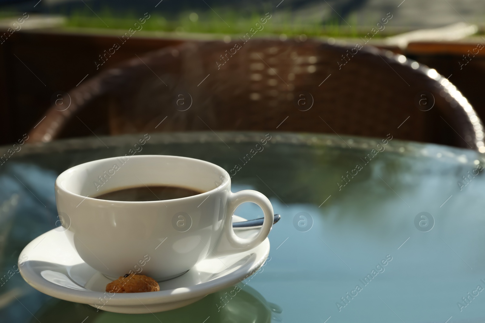 Photo of Cup of fresh aromatic coffee at table in cafe