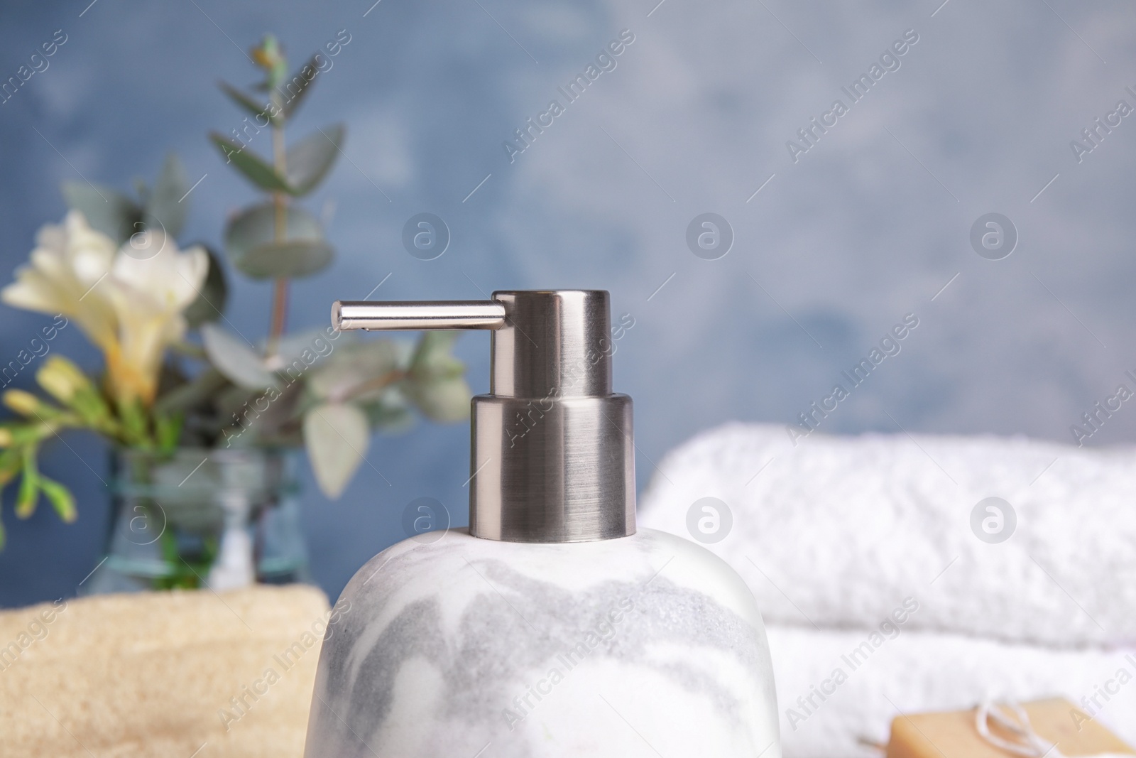 Photo of Modern marble soap dispenser in bathroom, closeup