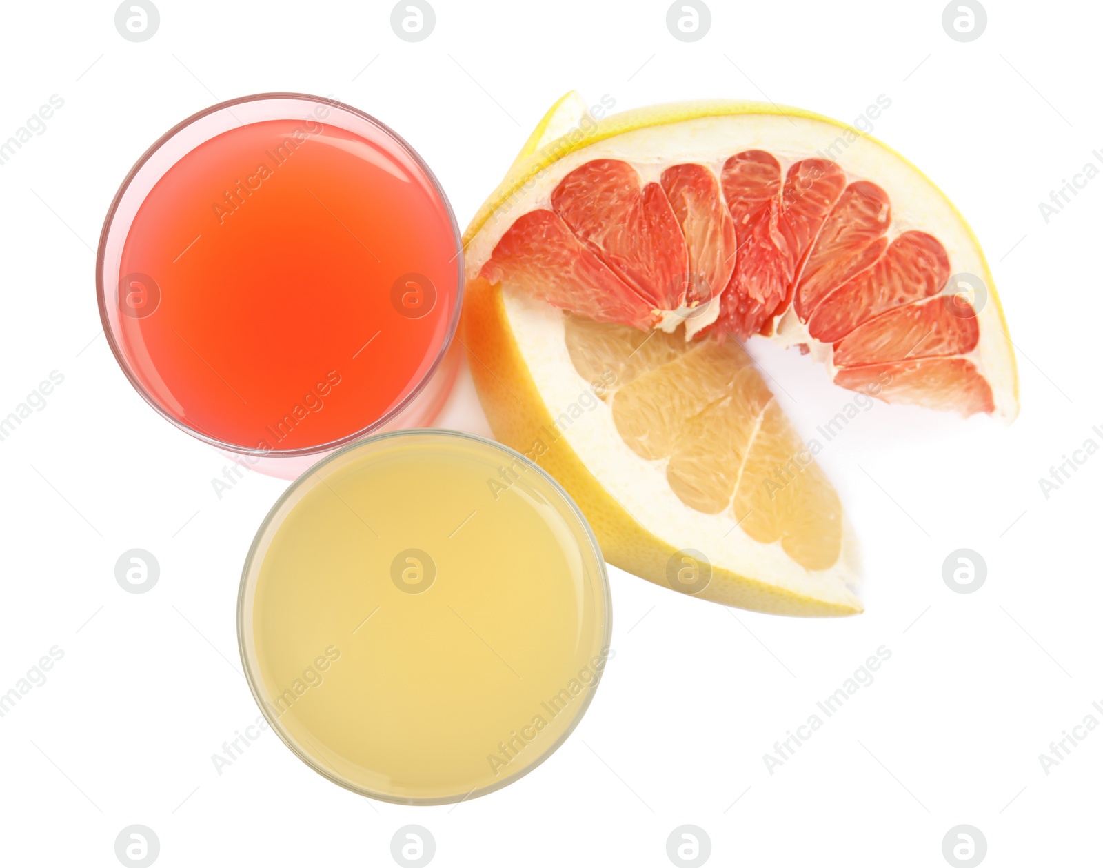 Photo of Glasses of different pomelo juices and fruits isolated on white, top view