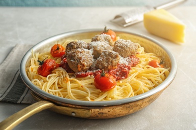 Photo of Pasta with meatballs and tomato sauce on table