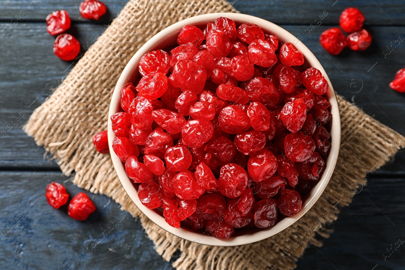 Photo of Bowl with tasty cherries on wooden background, top view. Dried fruits as healthy food