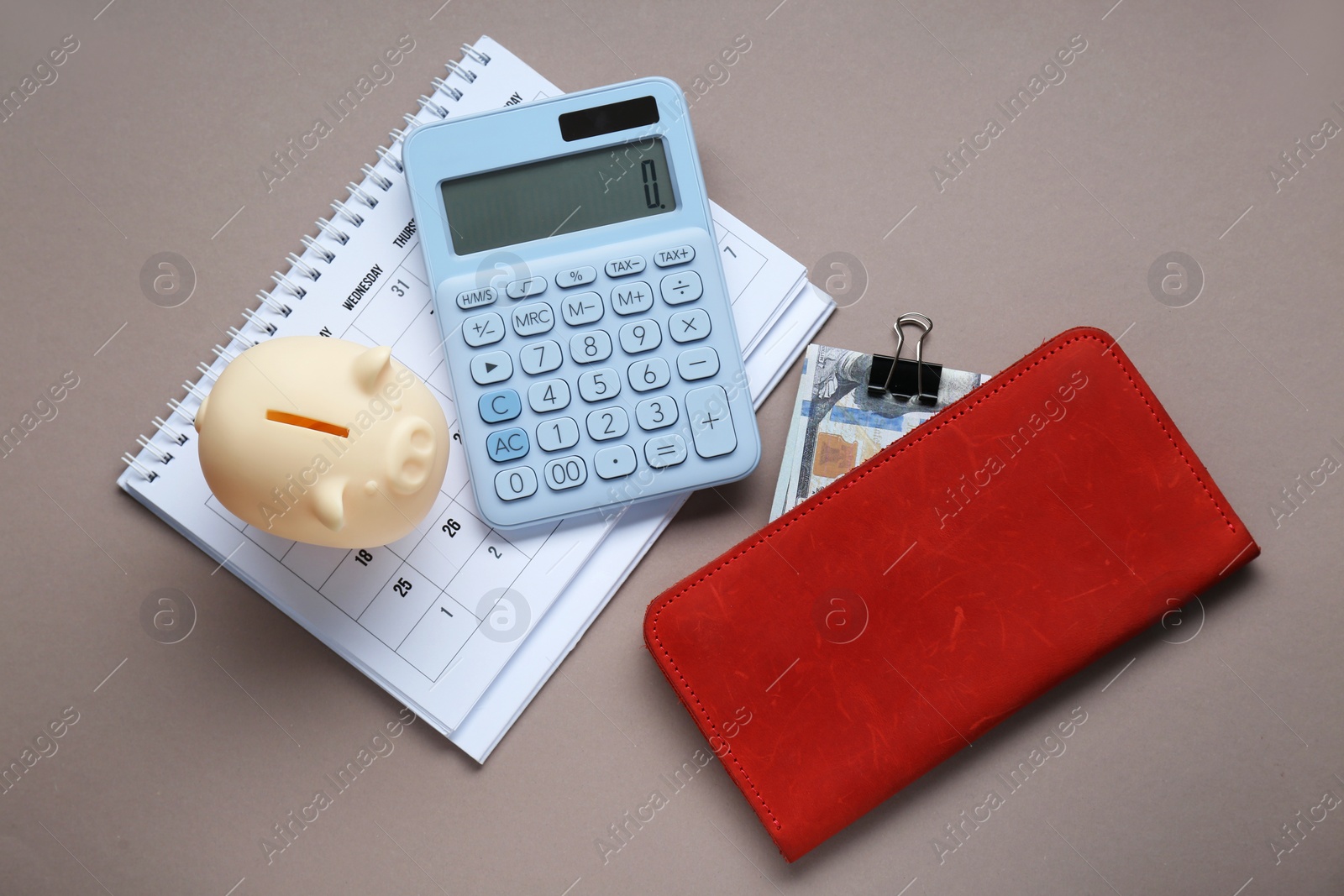 Photo of Flat lay composition with piggy bank and calculator on grey background