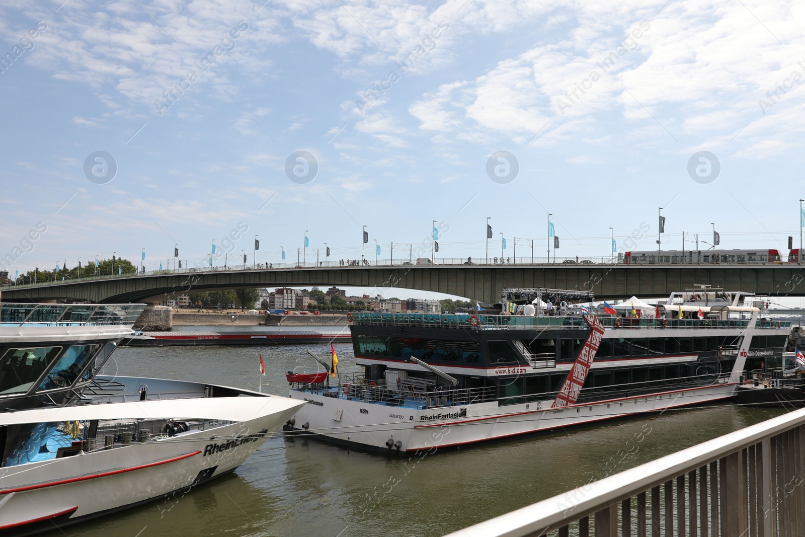 Photo of Cologne, Germany - August 28, 2022: Picturesque view of a modern bridge over river and ferry boat