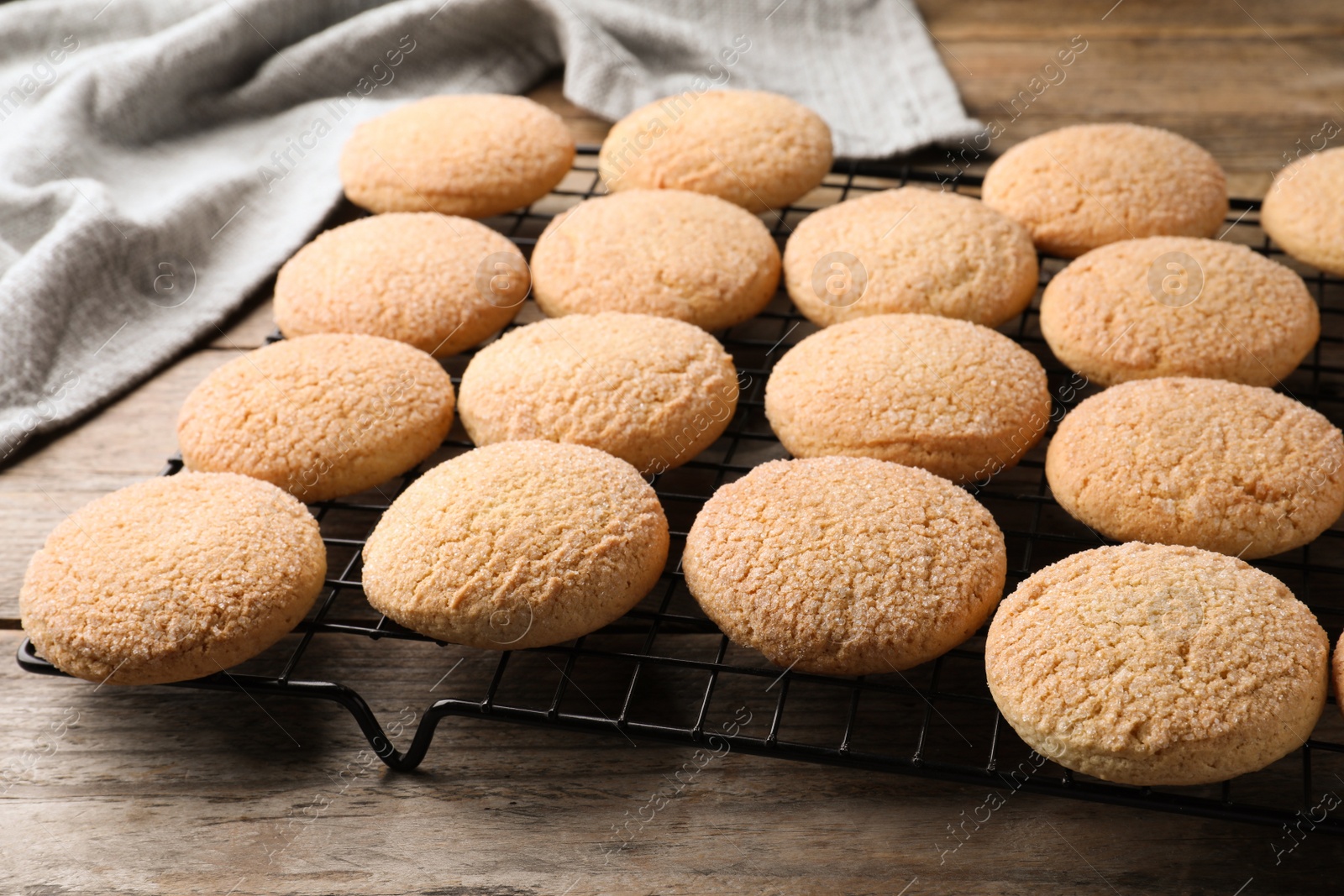 Photo of Many tasty sugar cookies on wooden table, closeup