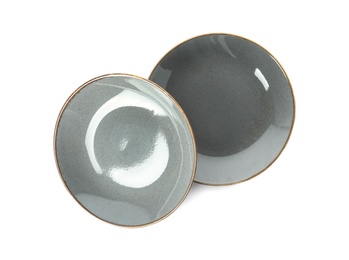 New grey ceramic plates on white background