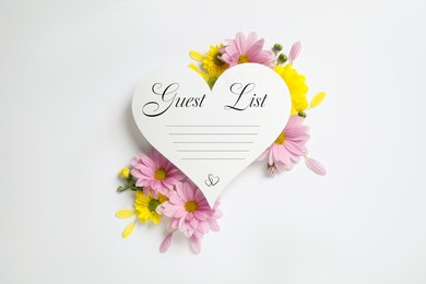Image of Beautiful flowers and guest list on white background, top view