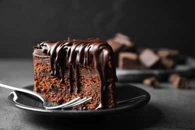 Tasty chocolate cake served on grey table