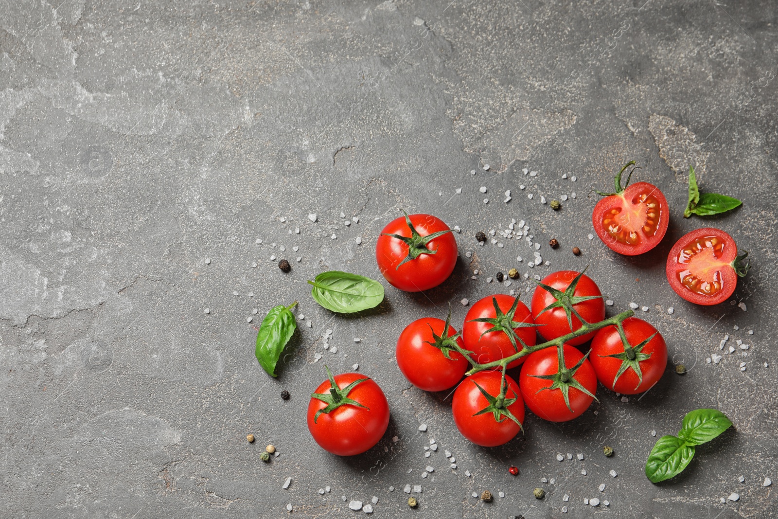 Photo of Flat lay composition with cherry tomatoes on stone background. Space for text