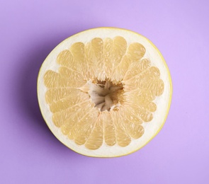 Photo of Fresh cut pomelo fruit on lilac background, top view