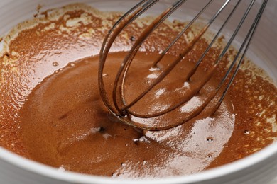 Whipping cream from instant coffee granules in bowl, closeup