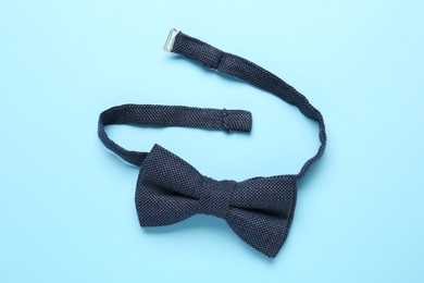 Photo of Stylish bow tie on light blue background, top view