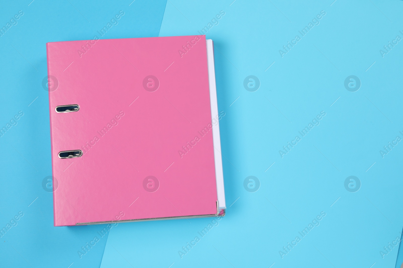 Photo of One office folder on light blue background, top view. Space for text