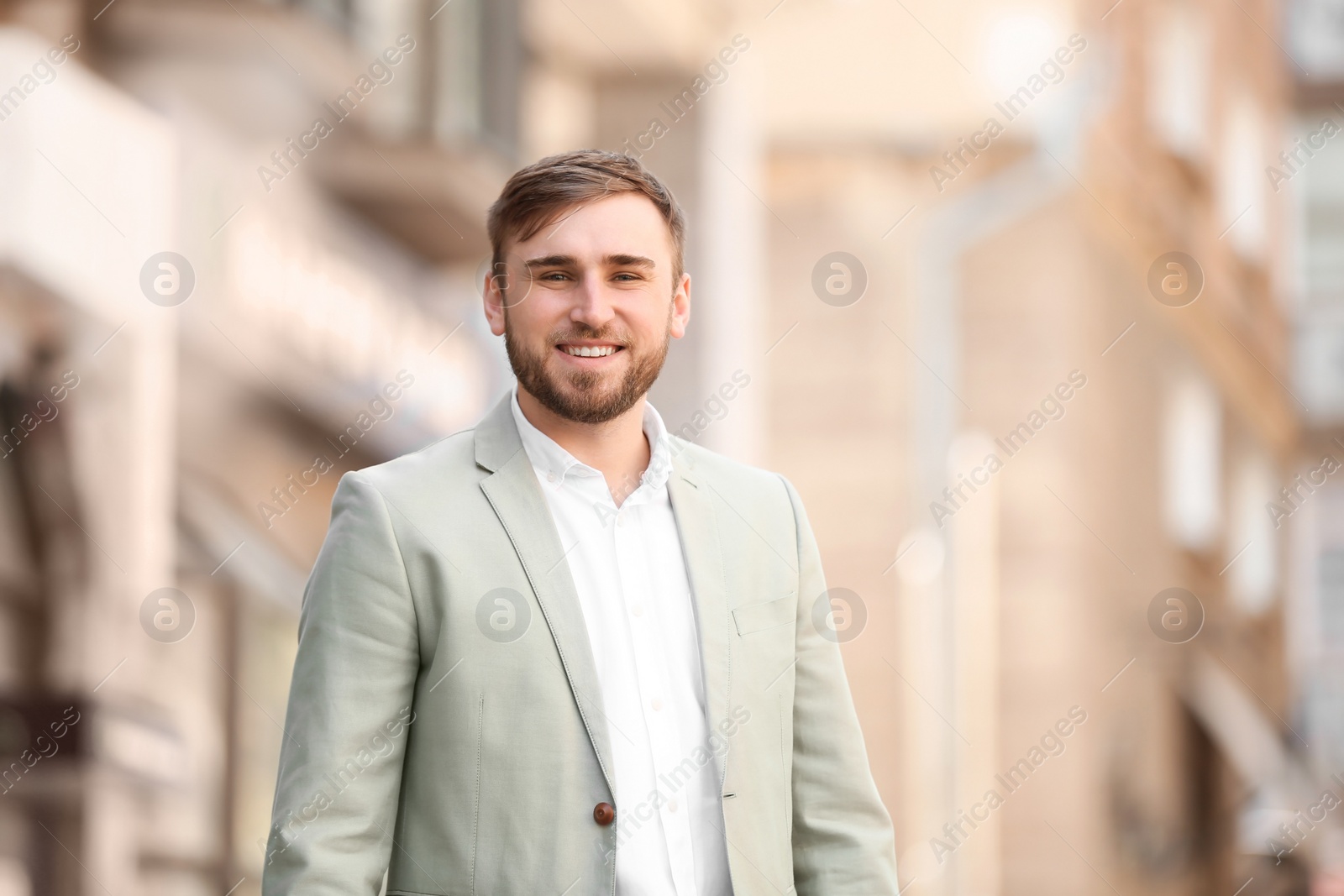 Photo of Portrait of young businessman in stylish outfit outdoors