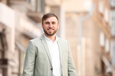 Portrait of young businessman in stylish outfit outdoors