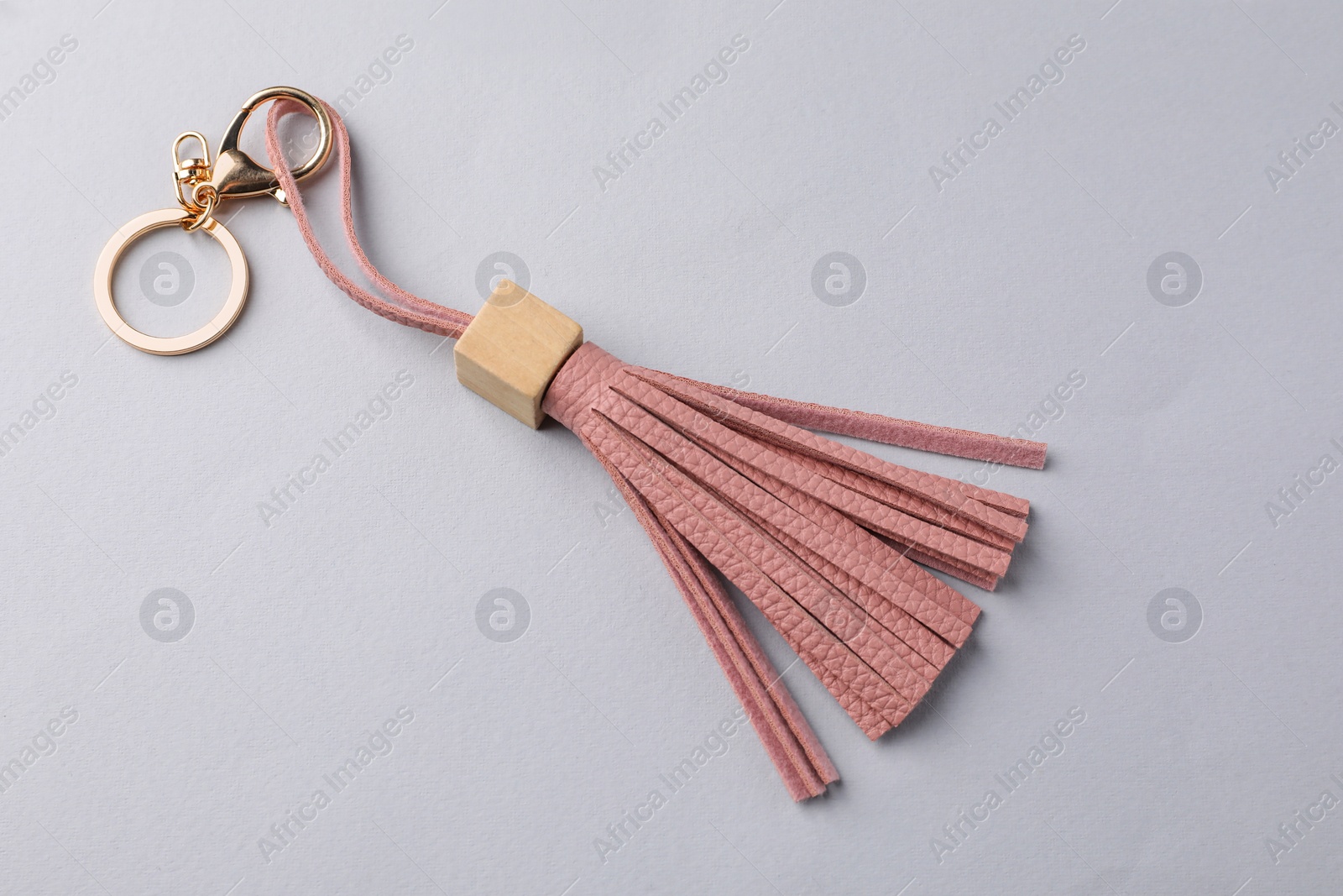 Photo of Pink leather keychain on light grey background, above view