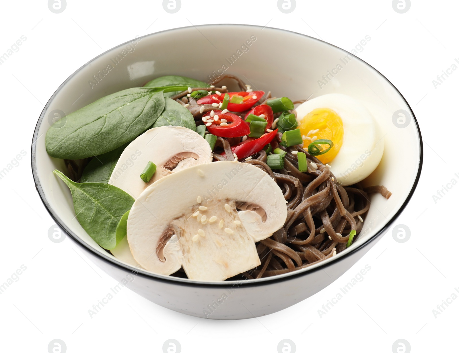 Photo of Tasty buckwheat noodles (soba) with chili pepper, egg, mushrooms and spinach in bowl isolated on white