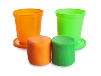 Colorful play dough and containers on white background