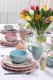 Photo of Festive table setting with beautiful flowers. Easter celebration