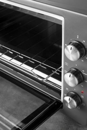 Photo of Open electric oven, closeup view. Cooking appliance