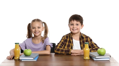 Happy children with healthy food for school lunch at desk on white background