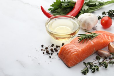 Fresh salmon and ingredients for marinade on white marble table. Space for text