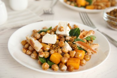Photo of Delicious fresh chickpea salad on white wooden table