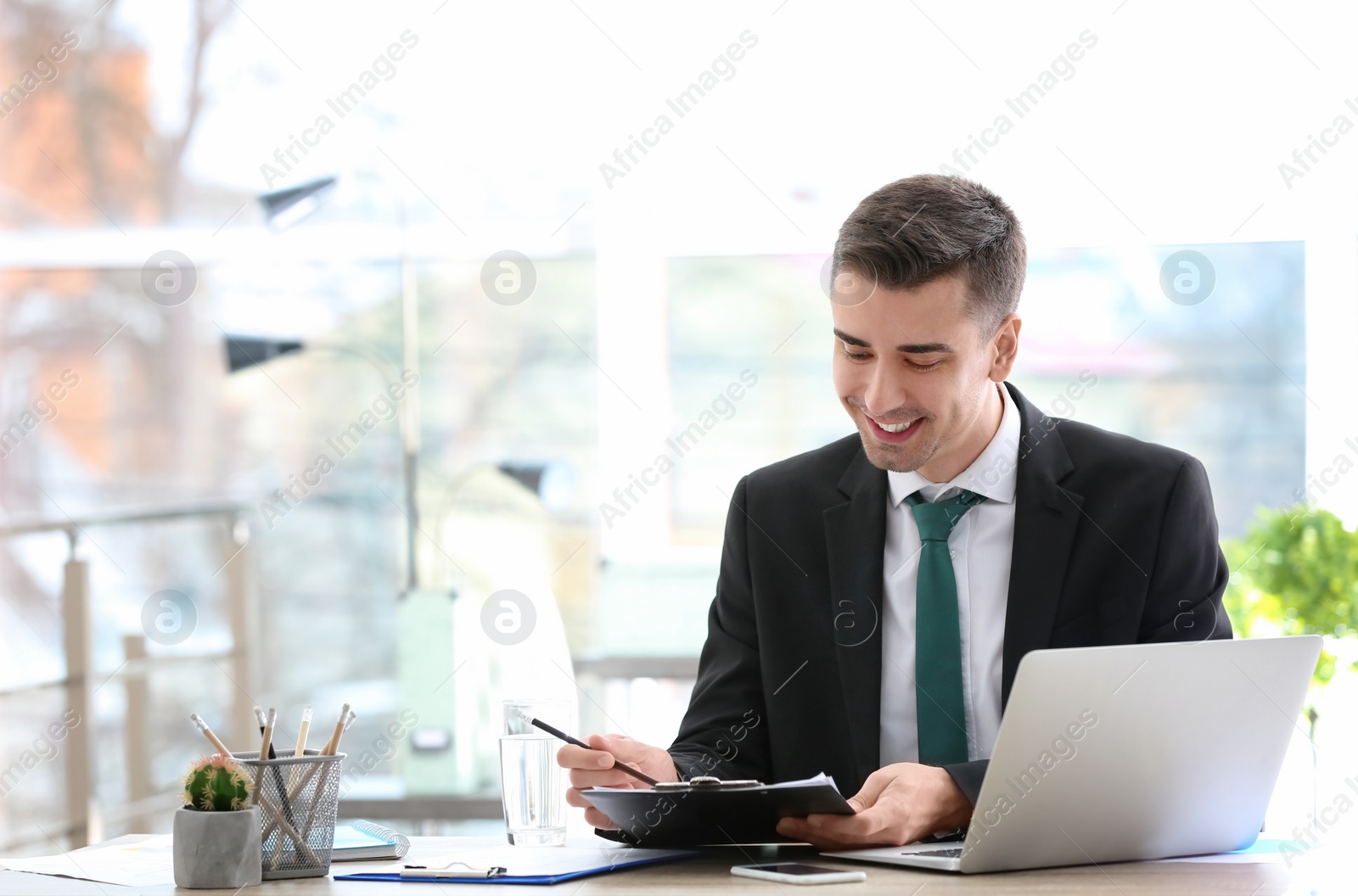 Photo of Consultant working at table in office